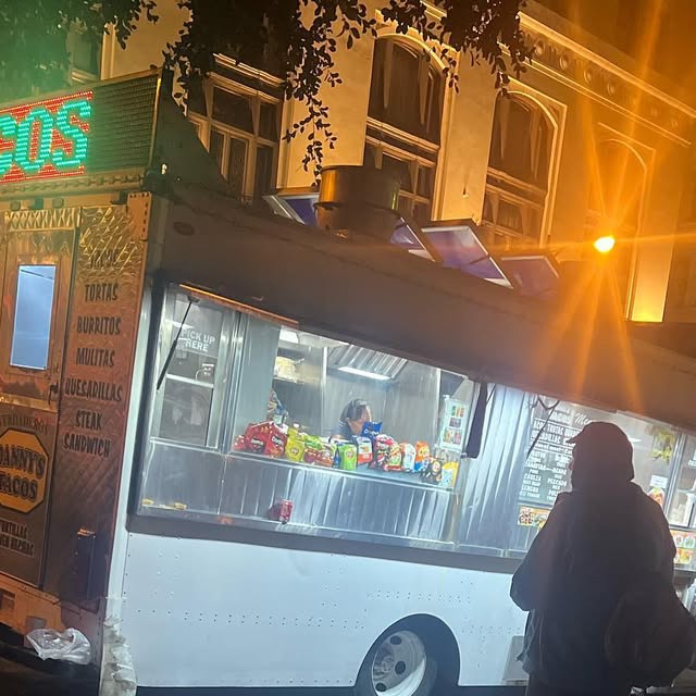 Danny's Tacos stand lit up at night in downtown Los Angeles